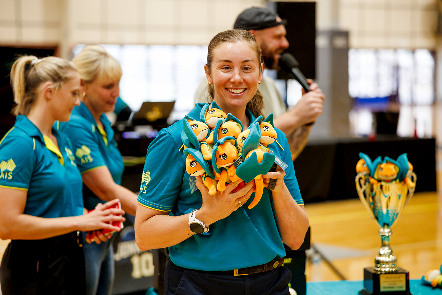 Al Viney holding a bunch of Lizzie stuffed toys