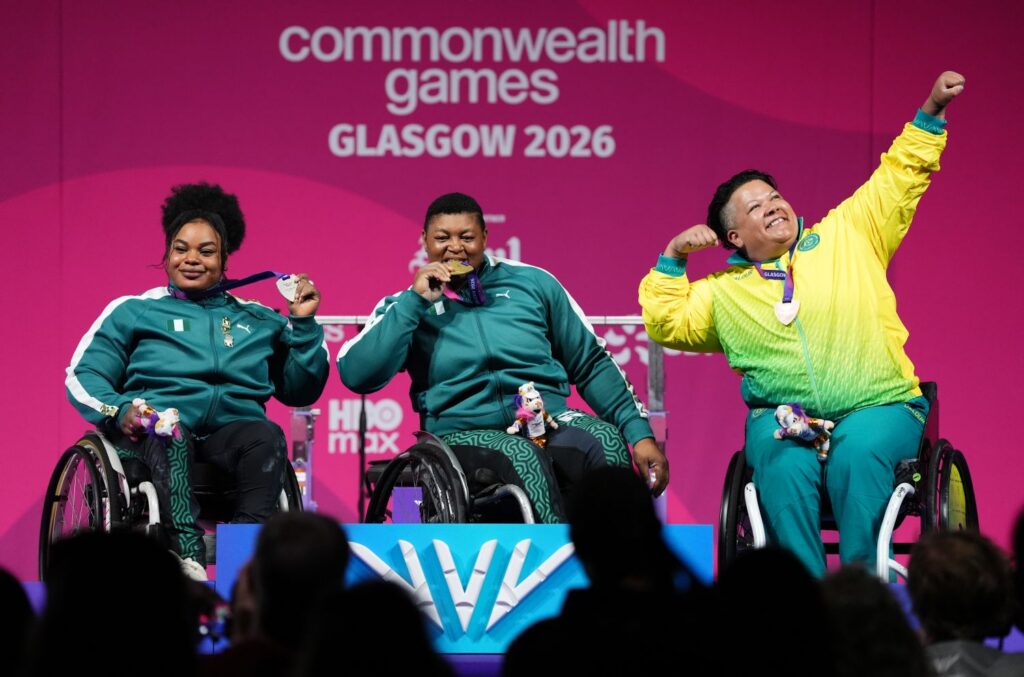 Hani Watson celebrates her bronze on the podium at the Glasgow 2026 Paralympic Games.