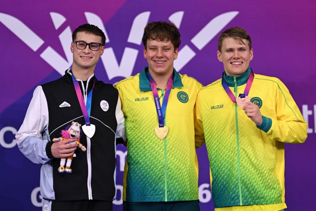 Para swimmers Tim Hodge and Beau Matthews on the podium at the Glasgow Commonwealth Games. 