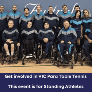 Group photo of para table tennis players in blue-gray jackets, several in wheelchairs, posing in a gym.
