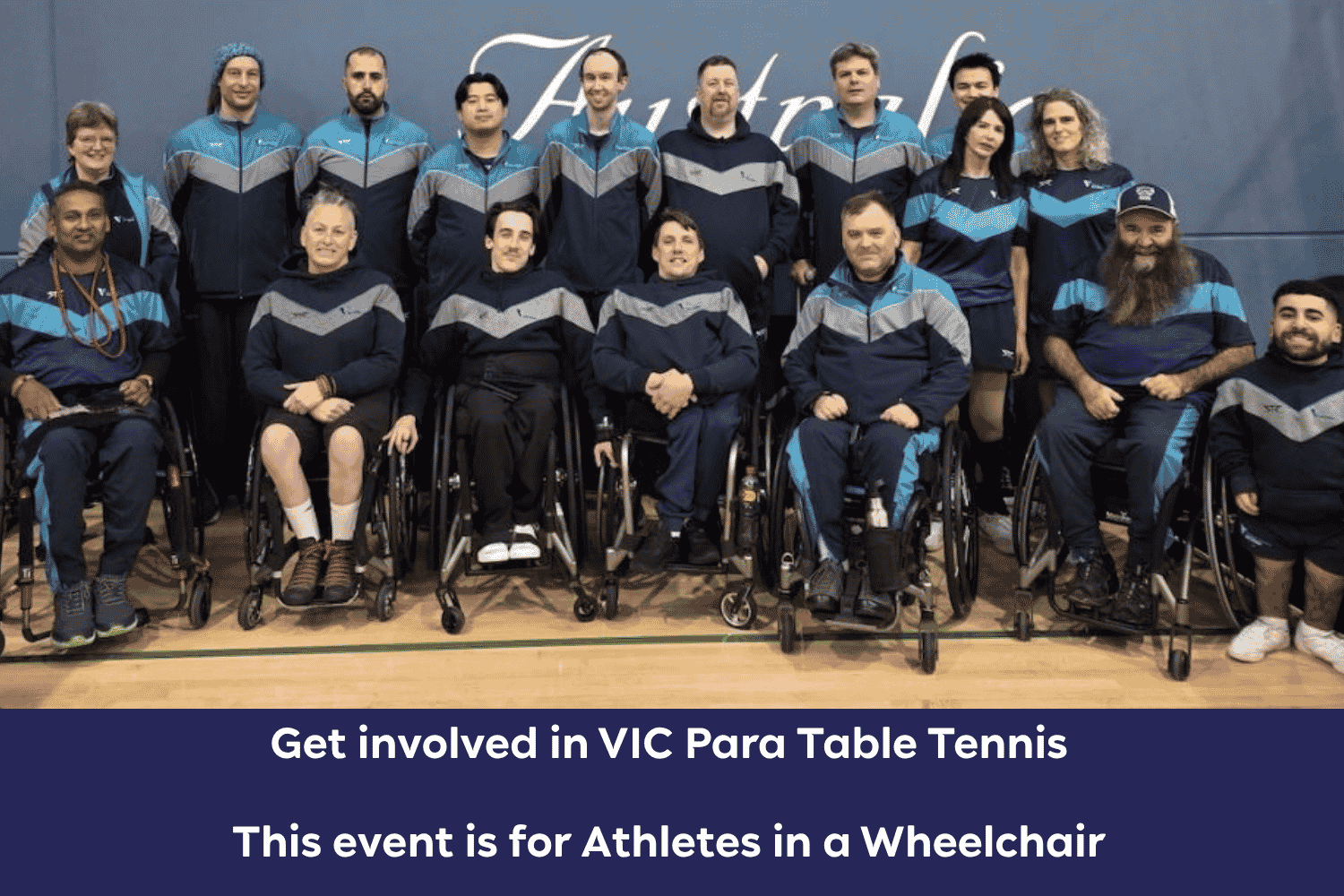 Group photo of wheelchair athletes in matching blue and gray uniforms, posing in a gym for a wheelchair table tennis team event.