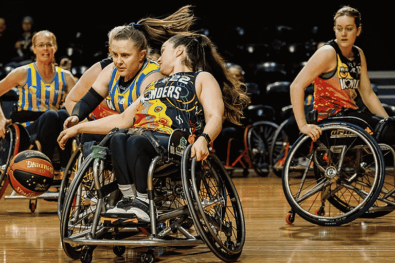 Wheelchair basketball players in action on a court, competing for the ball while steering their wheelchairs in motion.